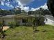 Charming one-story home with a welcoming front yard and mature trees at 6826 Driftwood Dr, Hudson, FL 34667