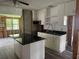 Kitchen area showcasing updated white cabinets and modern black countertops at 6826 Driftwood Dr, Hudson, FL 34667