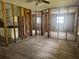 This kitchen features a granite countertop, white cabinets, sink, and open access to the living room at 6826 Driftwood Dr, Hudson, FL 34667