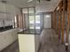 Open-concept kitchen with a central island and new white cabinets at 6826 Driftwood Dr, Hudson, FL 34667