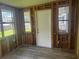 Sunroom area with multiple windows and a door leading to the outdoors at 6826 Driftwood Dr, Hudson, FL 34667
