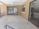 Outdoor patio offers a view of the pool and a glimpse of the kitchen through a large window at 6932 Pin Cherry Ln, Port Richey, FL 34668