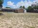 The backyard has a screened pool with a shed on the side of the home, the yard is bare with some grass at 6932 Pin Cherry Ln, Port Richey, FL 34668