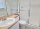 Bathroom featuring a sink and walk-in shower with tile surround at 6932 Pin Cherry Ln, Port Richey, FL 34668