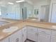 Bathroom featuring a large mirror, dual sinks, a spacious countertop, and plenty of storage at 6932 Pin Cherry Ln, Port Richey, FL 34668