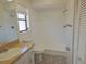 Updated bathroom featuring a tiled walk-in shower, modern fixtures, and ample natural light at 6932 Pin Cherry Ln, Port Richey, FL 34668