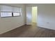 Well-lit bedroom featuring a window and closet space at 6932 Pin Cherry Ln, Port Richey, FL 34668