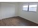 Bedroom with closet space, natural light, and vinyl flooring at 6932 Pin Cherry Ln, Port Richey, FL 34668