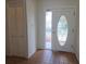 Bright entryway features a decorative glass door and tiled flooring leading into the home at 6932 Pin Cherry Ln, Port Richey, FL 34668