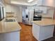 Well-lit kitchen featuring white cabinetry, stainless steel appliances, and stone countertops at 6932 Pin Cherry Ln, Port Richey, FL 34668