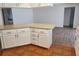 Kitchen with white cabinetry, laminate countertops, and tile flooring at 6932 Pin Cherry Ln, Port Richey, FL 34668