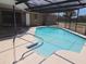Sparkling screened-in pool provides a refreshing outdoor space for relaxation and recreation at 6932 Pin Cherry Ln, Port Richey, FL 34668