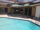 Exterior view of the screened pool, patio, and fenced in yard with access to the house at 6932 Pin Cherry Ln, Port Richey, FL 34668