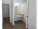 Hallway vanity area with a large mirror, drawers, lighting, and wood-look flooring at 6932 Pin Cherry Ln, Port Richey, FL 34668