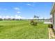 Expansive backyard overlooking a golf course with lush green grass and mature landscaping at 7059 Wirevine Dr, Brooksville, FL 34602
