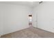 Bright bedroom with neutral carpeting and white walls, creating a clean, minimalist aesthetic at 7059 Wirevine Dr, Brooksville, FL 34602