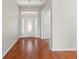 Bright foyer with hardwood floors, a decorative front door, and an open view into other rooms at 7059 Wirevine Dr, Brooksville, FL 34602