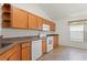 Well-maintained kitchen with updated appliances, wood cabinets, and a tile backsplash and floors at 7059 Wirevine Dr, Brooksville, FL 34602
