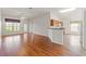Open-concept living room showcasing hardwood floors and a seamless transition to the kitchen area at 7059 Wirevine Dr, Brooksville, FL 34602