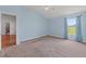 Spacious main bedroom with carpet flooring and a scenic view from the window at 7059 Wirevine Dr, Brooksville, FL 34602
