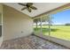 Relaxing screened patio with brick flooring overlooking a golf course and picturesque landscape at 7059 Wirevine Dr, Brooksville, FL 34602