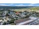 Aerial view shows the property near a lake and a shopping center at 7133 Box Elder Dr, Port Richey, FL 34668