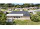 An aerial view of home highlighting backyard, roof, mature landscaping, and neighborhood at 7133 Box Elder Dr, Port Richey, FL 34668