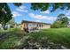 Fenced backyard with an outdoor patio area and green grass at 7133 Box Elder Dr, Port Richey, FL 34668