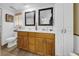 Bathroom featuring a double sink vanity with white countertop and wooden cabinets at 7133 Box Elder Dr, Port Richey, FL 34668