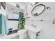 Bathroom featuring a pedestal sink and combination tub and shower at 7133 Box Elder Dr, Port Richey, FL 34668