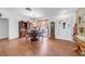 Bright dining room with wood floors, chandelier, a dining table for four, and lots of natural light at 7133 Box Elder Dr, Port Richey, FL 34668