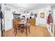 Bright dining room with a round table, wooden chairs, a chandelier, and hardwood floors at 7133 Box Elder Dr, Port Richey, FL 34668