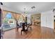 Bright dining room with wood floors, chandelier, a dining table for four, and lots of natural light at 7133 Box Elder Dr, Port Richey, FL 34668