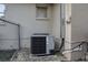 Exterior shot of air conditioner unit on gravel bed next to fence and building wall at 7133 Box Elder Dr, Port Richey, FL 34668