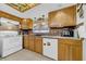Well-lit kitchen features tile flooring, wood cabinets, granite countertops, and modern appliances at 7133 Box Elder Dr, Port Richey, FL 34668