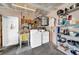 Bright laundry room with a sink, washer, dryer and storage shelving at 7133 Box Elder Dr, Port Richey, FL 34668
