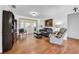 Bright and cozy living room features hardwood floors, comfortable seating, and natural light at 7133 Box Elder Dr, Port Richey, FL 34668