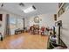 Bright living room featuring hardwood floors, natural light, and comfortable seating and decor at 7133 Box Elder Dr, Port Richey, FL 34668