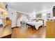 Bright main bedroom with hardwood floors, slider to deck, and bench seat at 7133 Box Elder Dr, Port Richey, FL 34668