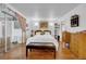 Bright main bedroom with hardwood floors, slider to deck, and bench seat at 7133 Box Elder Dr, Port Richey, FL 34668