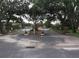 Gated entrance to the community, enhancing security and privacy for residents and guests with mature trees in the surrounding landscape at 7614 Radcliffe Cir # B213, Port Richey, FL 34668