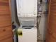 Convenient in-unit laundry featuring a stacked washer and dryer, along with shelving for organized storage of supplies at 7614 Radcliffe Cir # B213, Port Richey, FL 34668