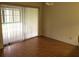 Versatile living space with sliding glass doors and hardwood floors, ideal for creating your own relaxing or entertaining area at 7614 Radcliffe Cir # B213, Port Richey, FL 34668