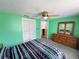Spacious bedroom with green walls, features closet and dresser with mirror enhancing the room's appeal at 8312 Split Rail Ln, Hudson, FL 34667