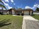 Charming single-story home featuring a well-manicured lawn and attached garage at 8312 Split Rail Ln, Hudson, FL 34667