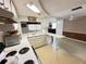 Bright kitchen featuring white cabinets, countertops, and a peninsula with view to dining area at 8312 Split Rail Ln, Hudson, FL 34667