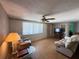 Cozy living room with a ceiling fan, a large window, and comfortable seating at 8312 Split Rail Ln, Hudson, FL 34667