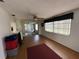Inviting living room with wood floors, fan, and large windows offering natural light and views at 8312 Split Rail Ln, Hudson, FL 34667