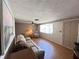 Comfortable living room with a ceiling fan, a large window, and neutral decor at 8312 Split Rail Ln, Hudson, FL 34667
