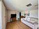 Inviting living room featuring wood-look floors, a ceiling fan, and a TV at 8312 Split Rail Ln, Hudson, FL 34667